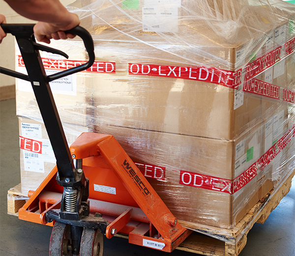 Pallet with expedited freight on it being delivered on dock