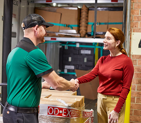 OD driver shaking hands with customer after delivering freight.